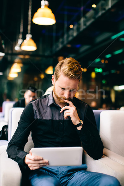 Redhair man with tablet Stock photo © boggy