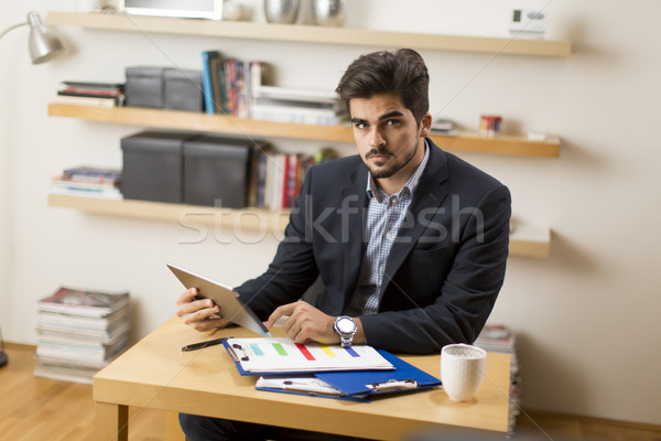 Businessman analyzing investment charts on digital tablet at off Stock photo © boggy
