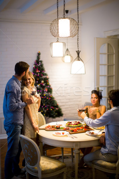 Friends celebrating Christmas or New Year eve Stock photo © boggy