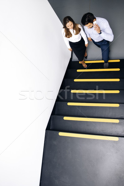 Jóvenes negocios Pareja escaleras oficina teléfono móvil Foto stock © boggy