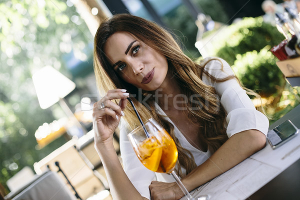 Attractive young woman drinking coctail in cafe outdoor Stock photo © boggy