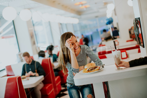 Güzel genç kadın oturma lokanta mutlu gıda Stok fotoğraf © boggy