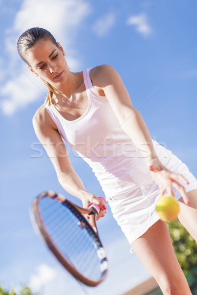 Stock photo: Young woman playing tennis