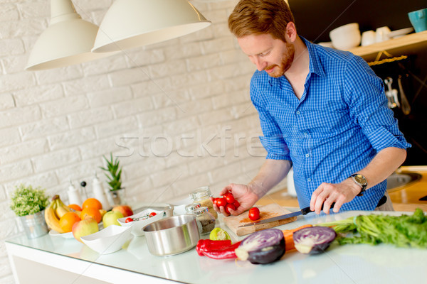 Redhair young man cooking food Stock photo © boggy