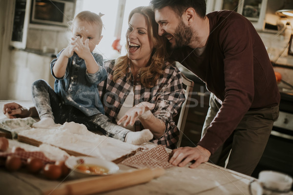 Stock photo: Happy family making pasta in the kitchen at home