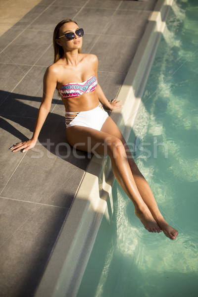 Pretty young woman on the poolside Stock photo © boggy