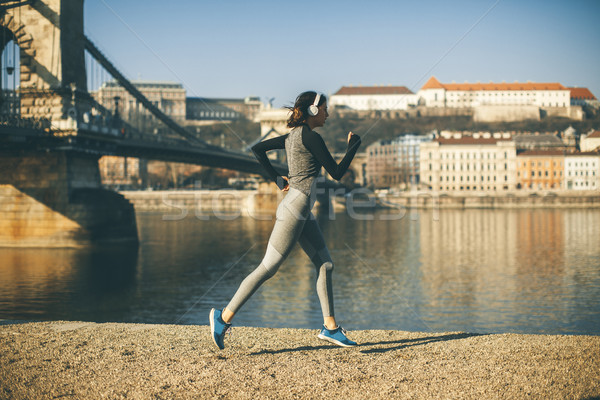 Woman in sportswear running on Danube river promenade in Budapes Stock photo © boggy