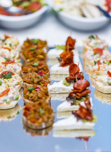 Colorful canape with vegetables and sausage on a slate plate Stock photo © boggy