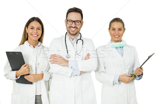 Portrait of three happy doctors who stand and smiling Stock photo © boggy