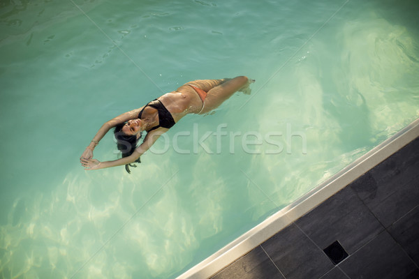 Woman in bikini  floating on water in the pool Stock photo © boggy
