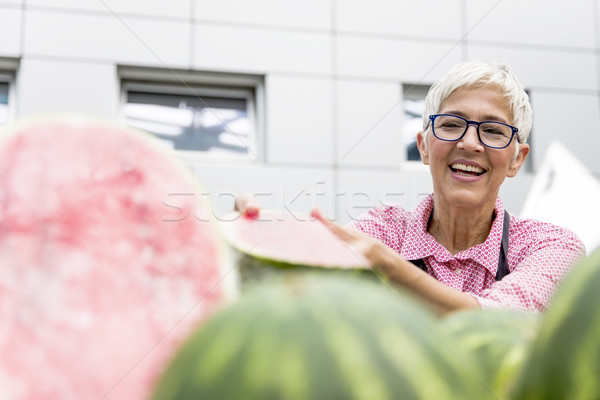 Senior woman sells watermelon on market Stock photo © boggy