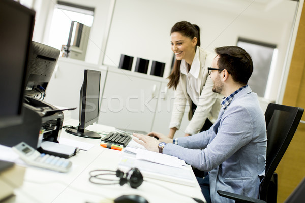 Young businesspeople in modern office Stock photo © boggy