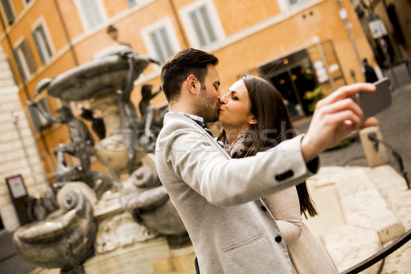 Young couple in love kissing and takes selfi in Rome Stock photo © boggy