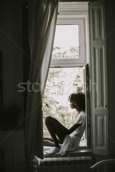 Ziemlich jungen schwarze Frau Sitzung Fenster Zimmer Stock foto © boggy