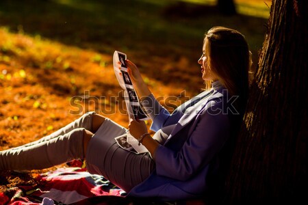 Terhes nő ül ősz park fiatal fa Stock fotó © boggy