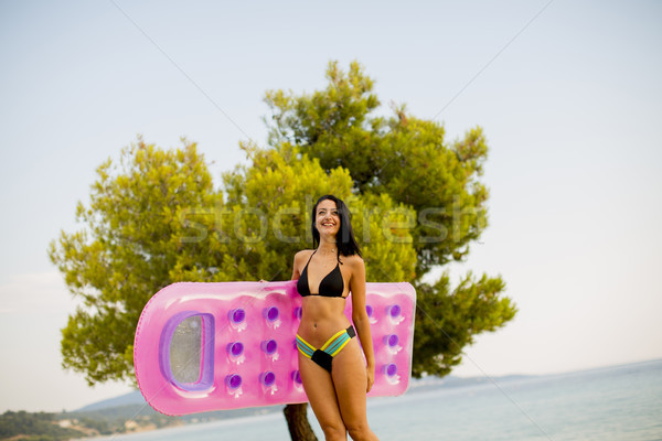 Jeune femme matelas plage joli eau fille Photo stock © boggy