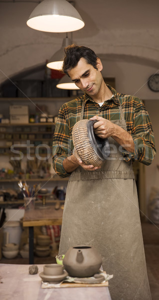 élégant jeune homme posant poterie atelier portrait [[stock_photo]] © boggy