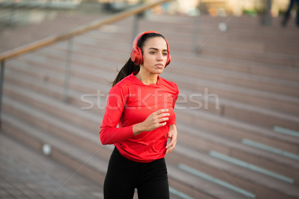 Active young beautiful woman running in urban enviroment Stock photo © boggy