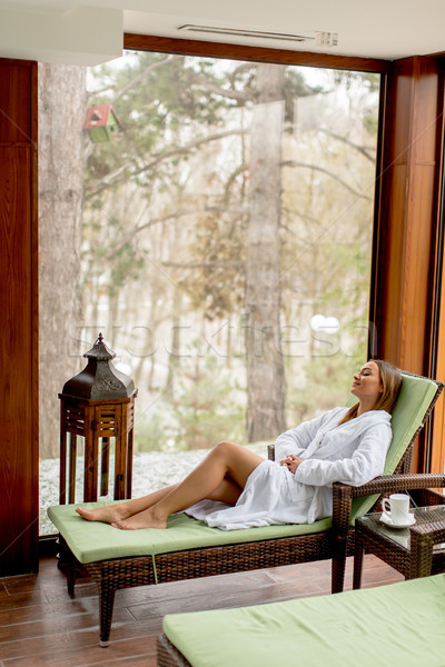 Pretty young woman relaxing by the indoor swimming pool at winte Stock photo © boggy