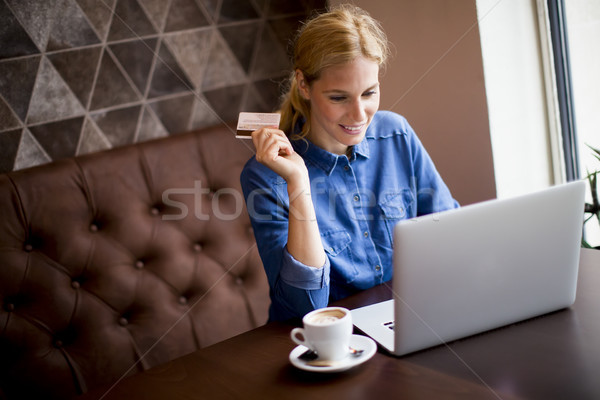 Young woman performs online shopping Stock photo © boggy