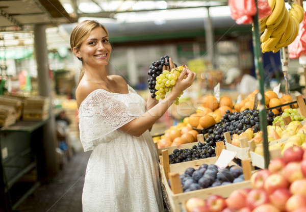 Young woman buying fruits on the market Stock photo © boggy