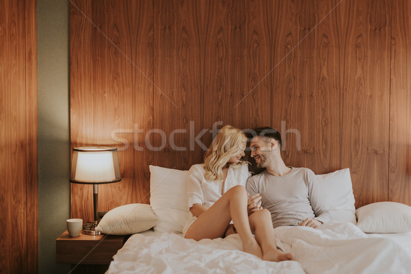 Fiatal felnőtt heteroszexuális pár ágy hálószoba otthon nő Stock fotó © boggy