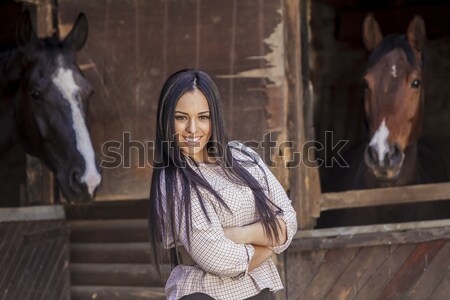 Pretty young woman in the stable Stock photo © boggy