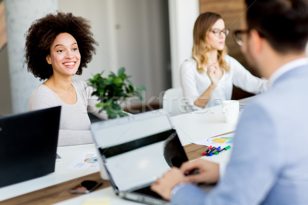 Business people around table during staff meeting Stock photo © boggy