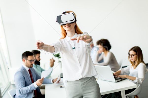 Young woman using virtual reality simulator in the office Stock photo © boggy