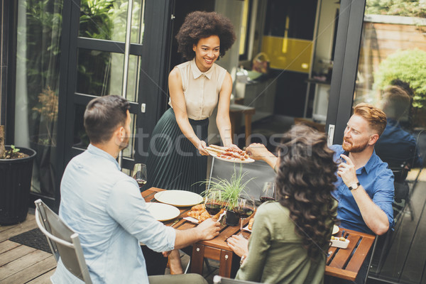 Cheerful young people have lunch in the courtyard and have a fun Stock photo © boggy