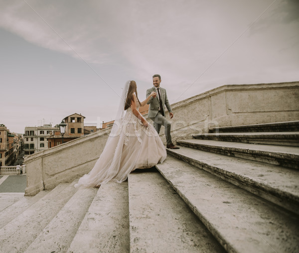 Bride and groom walking outdoors at Spagna Square and Trinita' d Stock photo © boggy