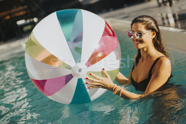 Young woman with ball in the pool Stock photo © boggy