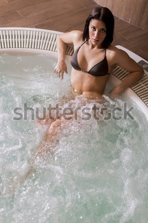 Pretty young woman relaxing in the bubble bath pool Stock photo © boggy