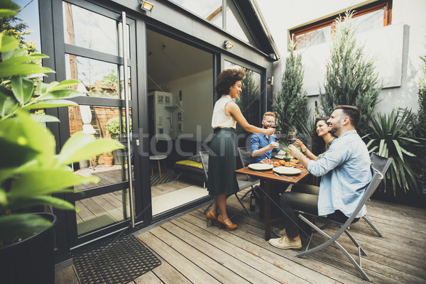 Cheerful young people have lunch in the courtyard and have a fun Stock photo © boggy