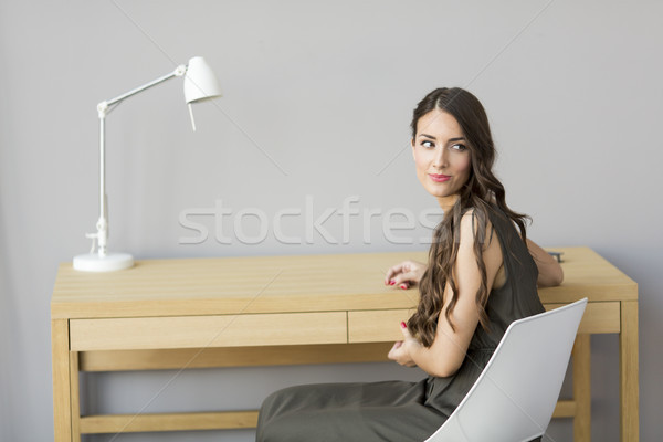 Woman sitting by table in the room Stock photo © boggy