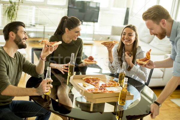 Group of young people eating pizza and drinking cider in the mod Stock photo © boggy