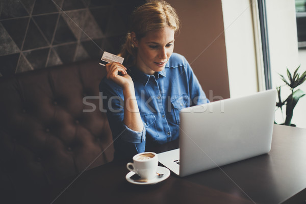 Young woman performs online shopping Stock photo © boggy