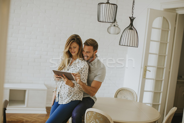 Couple using digital tablet together Stock photo © boggy