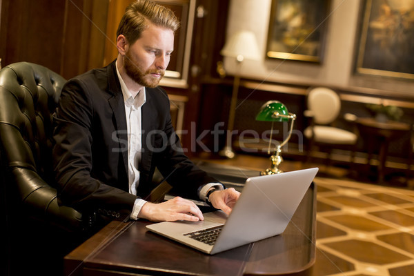 Stock photo: Young business man in workroom