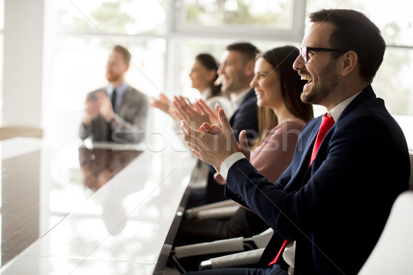 Businesspeople applauding while in a meeting at office Stock photo © boggy