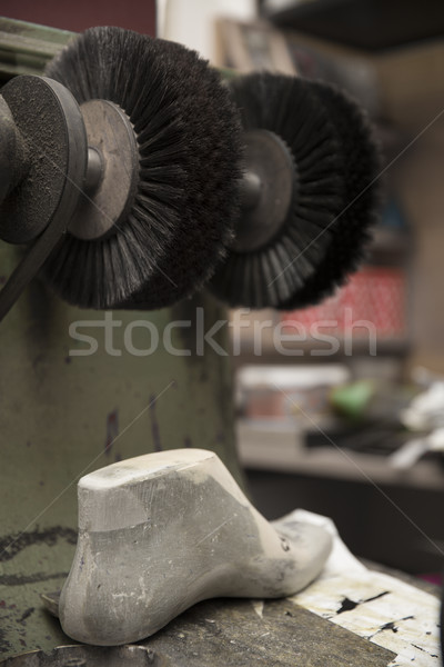 Shoe polisher in the shoemaker workshop Stock photo © boggy