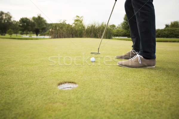 Young man playing golf on the golf course Stock photo © boggy