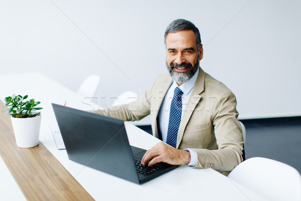 Bonito empresário trabalhando laptop escritório Foto stock © boggy