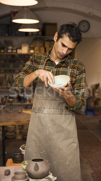 élégant jeune homme posant poterie atelier portrait [[stock_photo]] © boggy