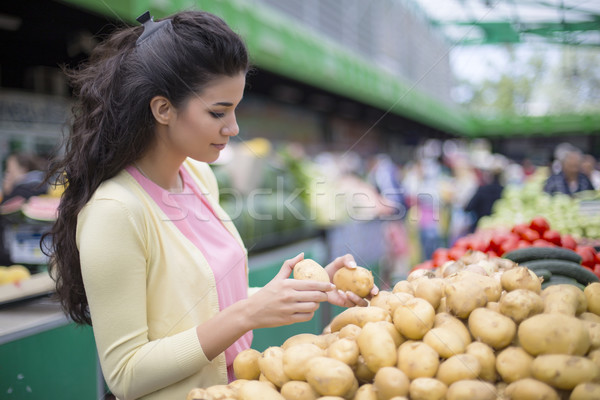Pretty young woman buying vegetables on the market Stock photo © boggy