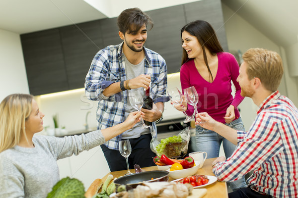 Young people at the table in kitchen Stock photo © boggy