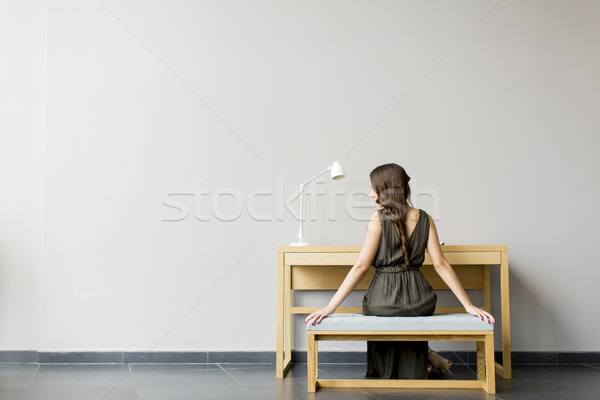 Woman sitting by table in the room Stock photo © boggy