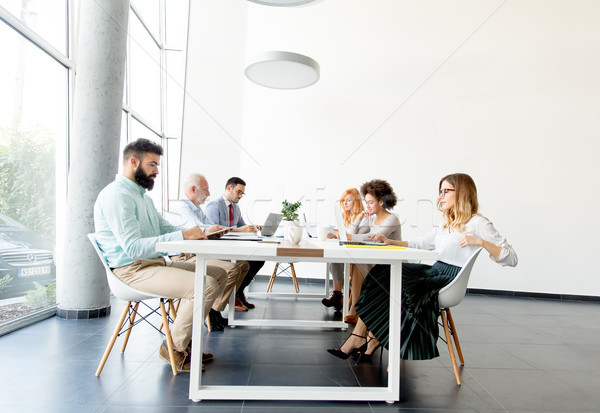 Business people around table during staff meeting Stock photo © boggy