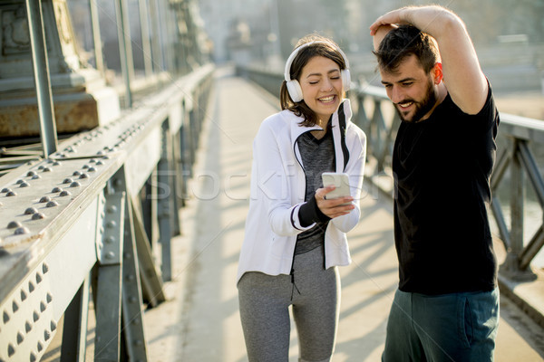 Sportos pár jogging város fiatal telefon Stock fotó © boggy