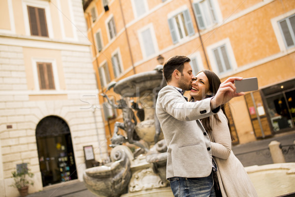 Young couple in love kissing and takes selfi in Rome Stock photo © boggy